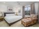 Comfortable bedroom with a queen bed, tile floors, and neutral-colored walls at 8433 E Cholla St, Scottsdale, AZ 85260