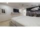 Modern bedroom with a king-size bed, ceiling fan, and a decorative wall art at 8433 E Cholla St, Scottsdale, AZ 85260