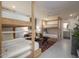 Cozy bedroom featuring custom wooden bunk beds, seating area, and a ceiling fan at 8433 E Cholla St, Scottsdale, AZ 85260