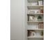 White bookshelf featuring books, desert-themed decorations, and a decorative plant at 8433 E Cholla St, Scottsdale, AZ 85260