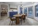 Inviting dining room featuring stylish light fixture, dining table, and a view of the pool area at 8433 E Cholla St, Scottsdale, AZ 85260
