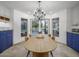 Bright dining area showcasing a modern chandelier, table, and sliding doors with a pool view at 8433 E Cholla St, Scottsdale, AZ 85260