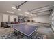 Spacious garage featuring a ping pong table, ample storage, and multiple garage doors for easy access at 8433 E Cholla St, Scottsdale, AZ 85260