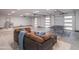 Bright and open garage space equipped with multiple car doors, ping pong table and a comfortable seating area at 8433 E Cholla St, Scottsdale, AZ 85260