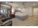 Bedroom featuring a king bed, ceiling fan, outdoor access, and stylish decor at 8433 E Cholla St, Scottsdale, AZ 85260