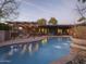 Beautiful backyard with a large swimming pool, covered patio, and outdoor seating area at 8433 E Cholla St, Scottsdale, AZ 85260