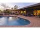 Expansive backyard with a sparkling pool, lounge seating, dining area, and beautifully landscaped surroundings at 8433 E Cholla St, Scottsdale, AZ 85260