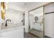 Well-lit bathroom featuring a dual sink vanity, modern fixtures, and a walk-in shower at 8602 W Clarendon Ave, Phoenix, AZ 85037