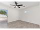 Bright bedroom with a ceiling fan and sliding glass doors leading to the backyard at 8602 W Clarendon Ave, Phoenix, AZ 85037