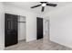 Bedroom featuring tile floors, a ceiling fan, a closet, and access to another room at 8602 W Clarendon Ave, Phoenix, AZ 85037