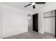 Bedroom featuring tile floors, a ceiling fan, a closet, and access to the bathroom at 8602 W Clarendon Ave, Phoenix, AZ 85037