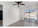 Bright bedroom with ceiling fan and sliding glass doors leading to the backyard at 8602 W Clarendon Ave, Phoenix, AZ 85037
