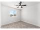Bedroom featuring tile floors, a ceiling fan, and a view out the window at 8602 W Clarendon Ave, Phoenix, AZ 85037