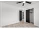 Bedroom features tile floors, a ceiling fan, a closet, and access to the bathroom at 8602 W Clarendon Ave, Phoenix, AZ 85037