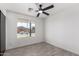Bedroom featuring tile floors, a ceiling fan, and a view out the window at 8602 W Clarendon Ave, Phoenix, AZ 85037