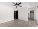 Bright bedroom features tile floors, a ceiling fan, and access to the bathroom at 8602 W Clarendon Ave, Phoenix, AZ 85037