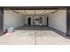 A spacious garage with white walls and a concrete floor at 8602 W Clarendon Ave, Phoenix, AZ 85037