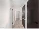 Hallway with sleek, dark paneled doors and light gray tile floors at 8602 W Clarendon Ave, Phoenix, AZ 85037