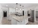 Modern kitchen with white cabinets, stainless steel appliances, quartz countertops, and a kitchen island at 8602 W Clarendon Ave, Phoenix, AZ 85037
