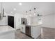Modern kitchen with a quartz island, stainless steel appliances, and stylish pendant lighting at 8602 W Clarendon Ave, Phoenix, AZ 85037