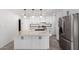 Bright kitchen showcasing a center island with quartz countertop and stainless steel refrigerator at 8602 W Clarendon Ave, Phoenix, AZ 85037