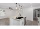 Stylish kitchen island with quartz countertop, stainless steel dishwasher and modern faucet at 8602 W Clarendon Ave, Phoenix, AZ 85037