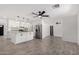 Open-concept kitchen and living room with white cabinets, new floors and stainless steel appliances at 8602 W Clarendon Ave, Phoenix, AZ 85037