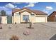 Charming single-story home featuring desert landscaping and an attached two-car garage at 8900 E Rainier Dr, Gold Canyon, AZ 85118