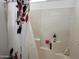 A tub/shower combo with a shower curtain and toiletry products on the side wall at 8900 E Rainier Dr, Gold Canyon, AZ 85118