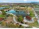 Aerial view of community lake, park, pathways, and covered sitting areas at 9960 E Revolution Dr, Mesa, AZ 85212