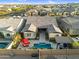 Aerial view of a home with a backyard pool, patio area, outdoor seating and desert landscaping at 9960 E Revolution Dr, Mesa, AZ 85212
