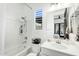 Bright bathroom with white tile backsplash, shower, vanity and plantation window shutters at 9960 E Revolution Dr, Mesa, AZ 85212