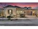 Charming single-story home featuring desert landscaping and a two-car garage at 9960 E Revolution Dr, Mesa, AZ 85212