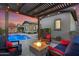 Relaxing backyard with a firepit, comfortable seating, and a view of the pool at 9960 E Revolution Dr, Mesa, AZ 85212