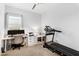 Bright office space featuring built-in desk, shelving, and modern exercise equipment at 9960 E Revolution Dr, Mesa, AZ 85212