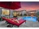 Backyard view with pool, loungers, firepit, and outdoor seating area at 9960 E Revolution Dr, Mesa, AZ 85212