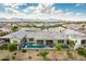 Beautiful aerial shot showcases a home with pool, landscaped yard, and mountain views at 11203 N Northfield St, Surprise, AZ 85388