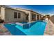An exterior view of the backyard featuring a refreshing pool and attached spa, perfect for relaxation at 11203 N Northfield St, Surprise, AZ 85388