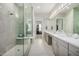 This sleek bathroom boasts double sinks, a seamless glass shower, and modern tile flooring at 11203 N Northfield St, Surprise, AZ 85388