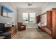 This bedroom is a versatile flex space with a pull-down Murphy bed, desk and wood-look tile at 11203 N Northfield St, Surprise, AZ 85388