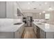 Bright kitchen features quartz countertops, stainless steel appliances, and gray cabinetry at 11203 N Northfield St, Surprise, AZ 85388
