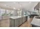 Open concept kitchen island leading into the Gathering room with pool table at 11203 N Northfield St, Surprise, AZ 85388