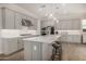 Kitchen boasts gray cabinets, hardwood floors, quartz countertops, and pendant lighting at 11203 N Northfield St, Surprise, AZ 85388