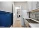 A view of the laundry room featuring a stainless steel sink and direct access to the home's interior at 11203 N Northfield St, Surprise, AZ 85388