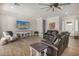 Bright living room featuring wood tile floors, neutral walls, and comfortable seating arrangements at 11203 N Northfield St, Surprise, AZ 85388