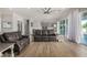 Elegant living space with light wood flooring, neutral walls, and a view into the kitchen at 11203 N Northfield St, Surprise, AZ 85388