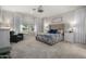 Cozy main bedroom with carpet, large bed, side tables, and many windows at 11203 N Northfield St, Surprise, AZ 85388