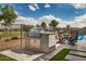 Outdoor kitchen with stainless steel gas grill and stacked stone accents on a tile patio with outdoor seating at 11203 N Northfield St, Surprise, AZ 85388