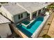 Aerial view of a backyard featuring a sparkling pool and spa, lounge area, and patio at 11203 N Northfield St, Surprise, AZ 85388