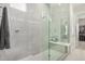 Modern seamless glass shower with a built-in bench and chrome fixtures at 11203 N Northfield St, Surprise, AZ 85388